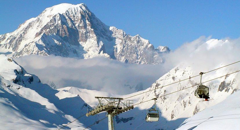 Skiers taking chairlift to top of mountain