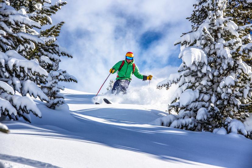 Skier skiing off piste in Pas De La Casa ski resort