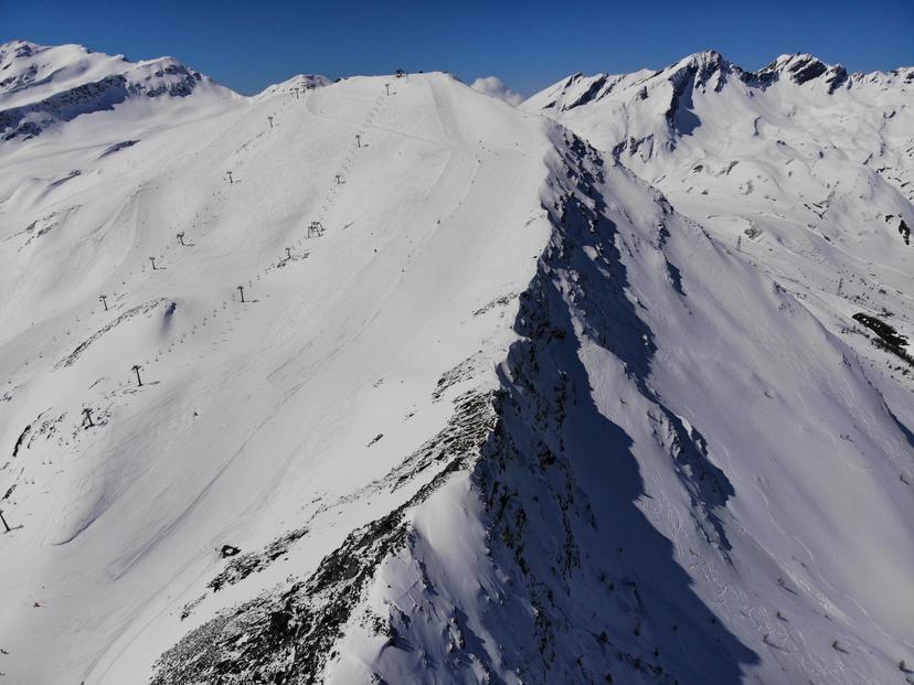 Chairlift and ski slope on mountain ridge