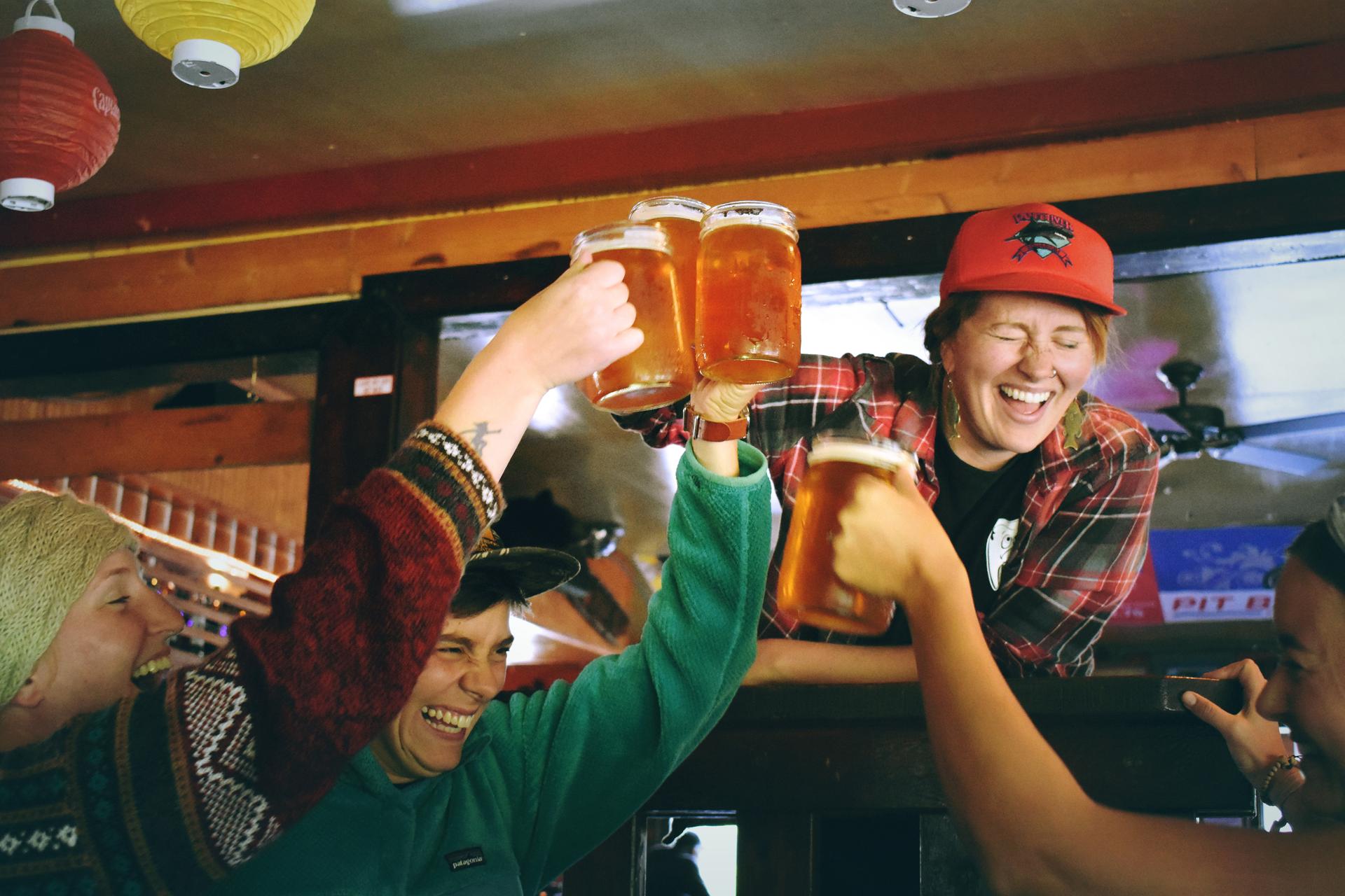 Skies enjoying apres ski party with beers