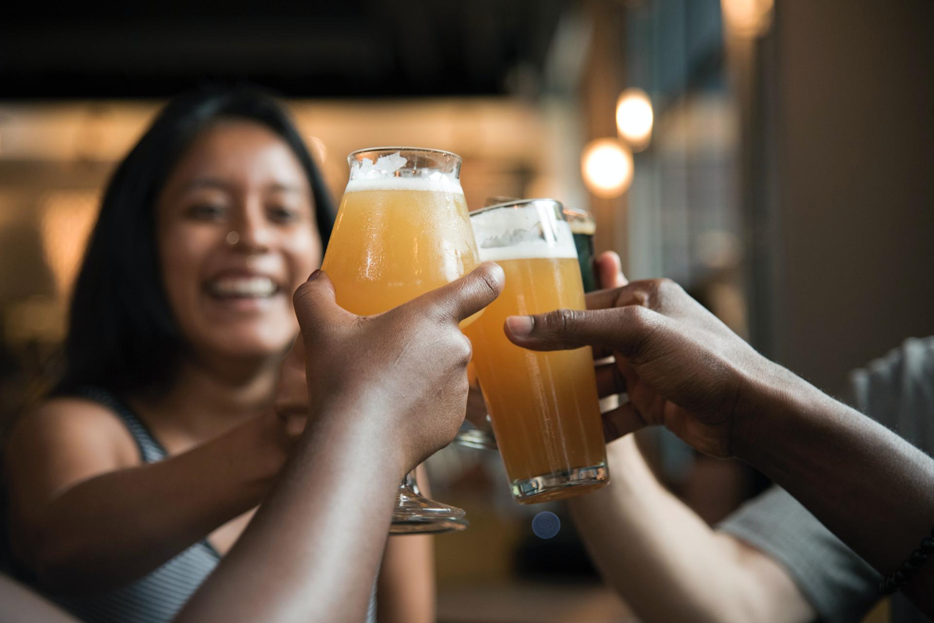 Friends giving cheers with beers on holiday